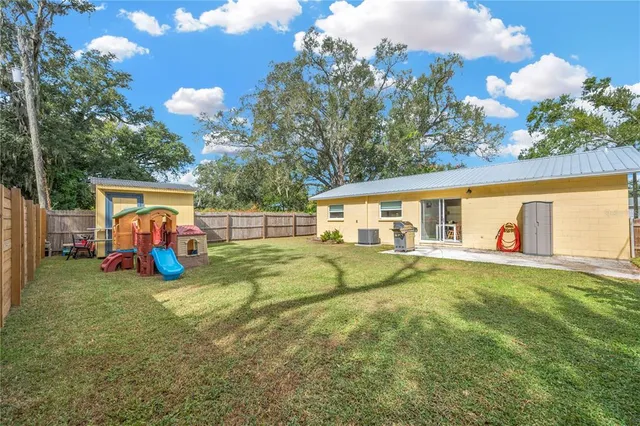 a front view of house with yard and trees
