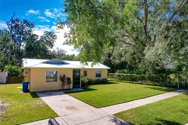 an aerial view of a house with a yard basket ball court and outdoor seating