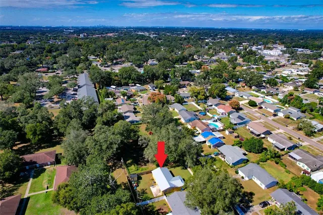 an aerial view of residential houses with city and outdoor space