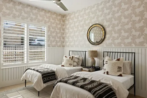 a bedroom with a large bed and a large window