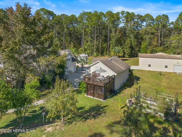 a kitchen with stainless steel appliances granite countertop a stove and a view of living room