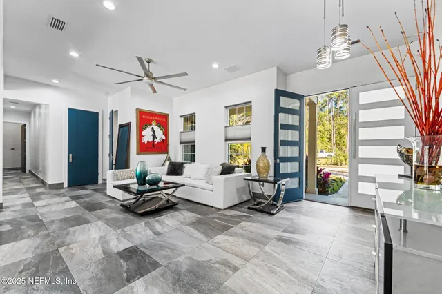 a bedroom with a bed and a dresser next to a window