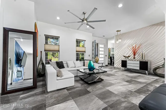 a spacious bedroom with a bed and glass windows