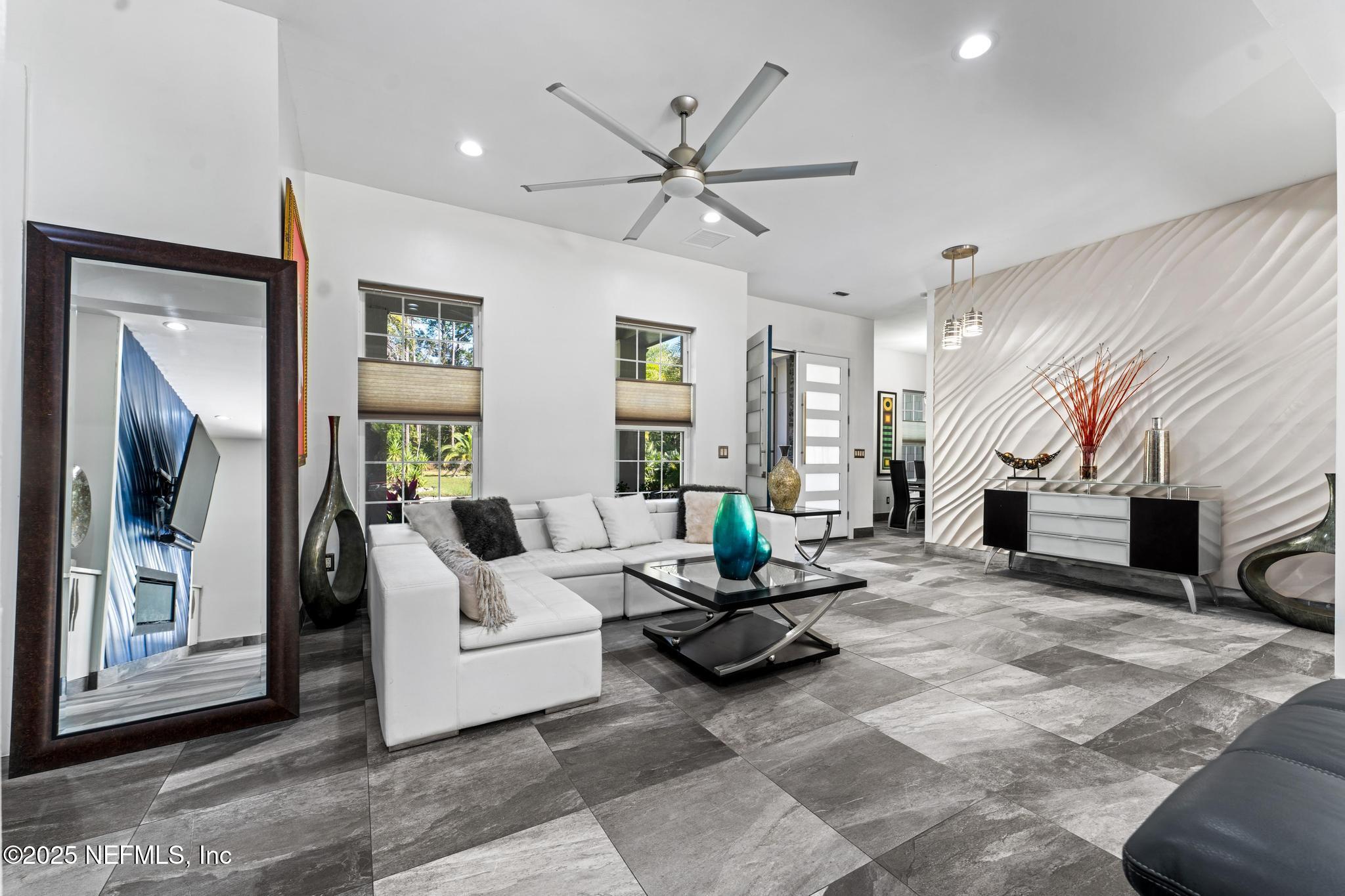 3010 Starratt Road Jacksonville, FL 32226 - Photo 20 of 106 a living room with furniture a fireplace and a large window
