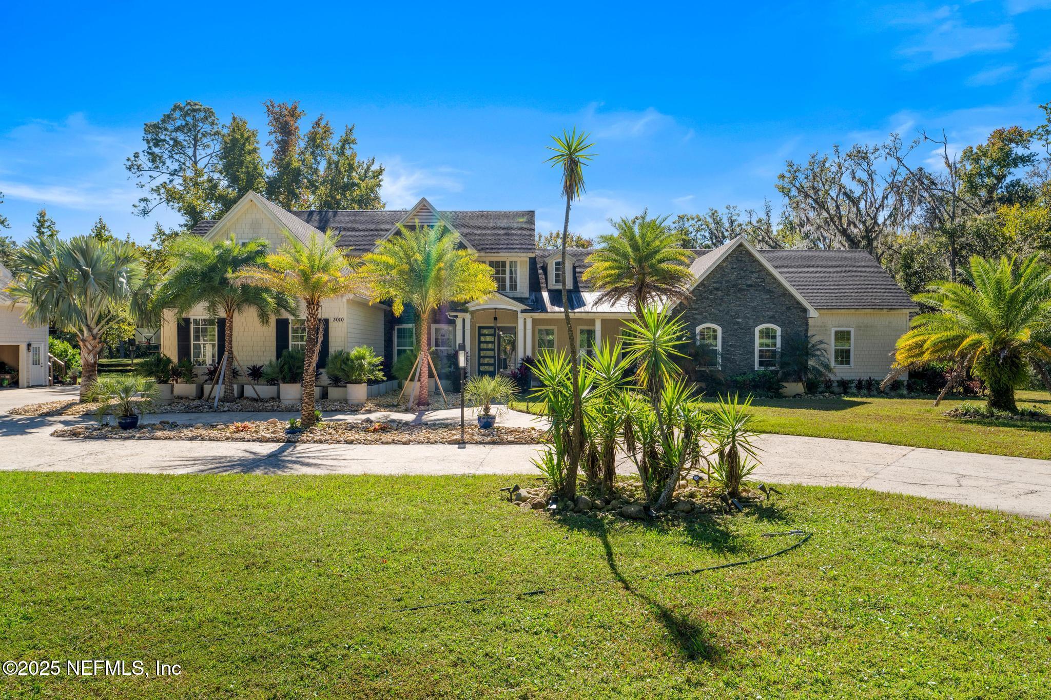 3010 Starratt Road Jacksonville, FL 32226 - Photo 2 of 106 a view of a swimming pool with tables and chairs under an umbrella