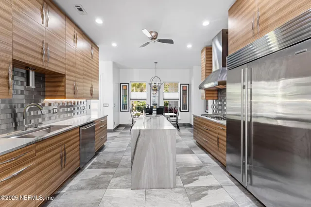 a spacious bathroom with a double vanity sink a large mirror and shower