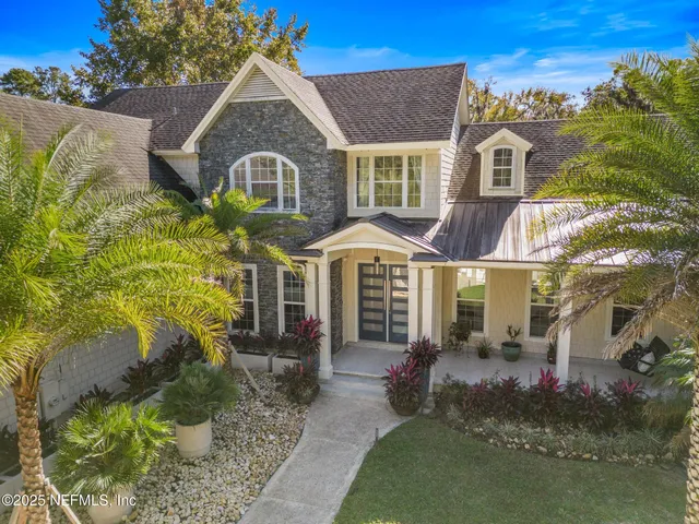 an aerial view of a house with a yard swimming pool outdoor seating and yard
