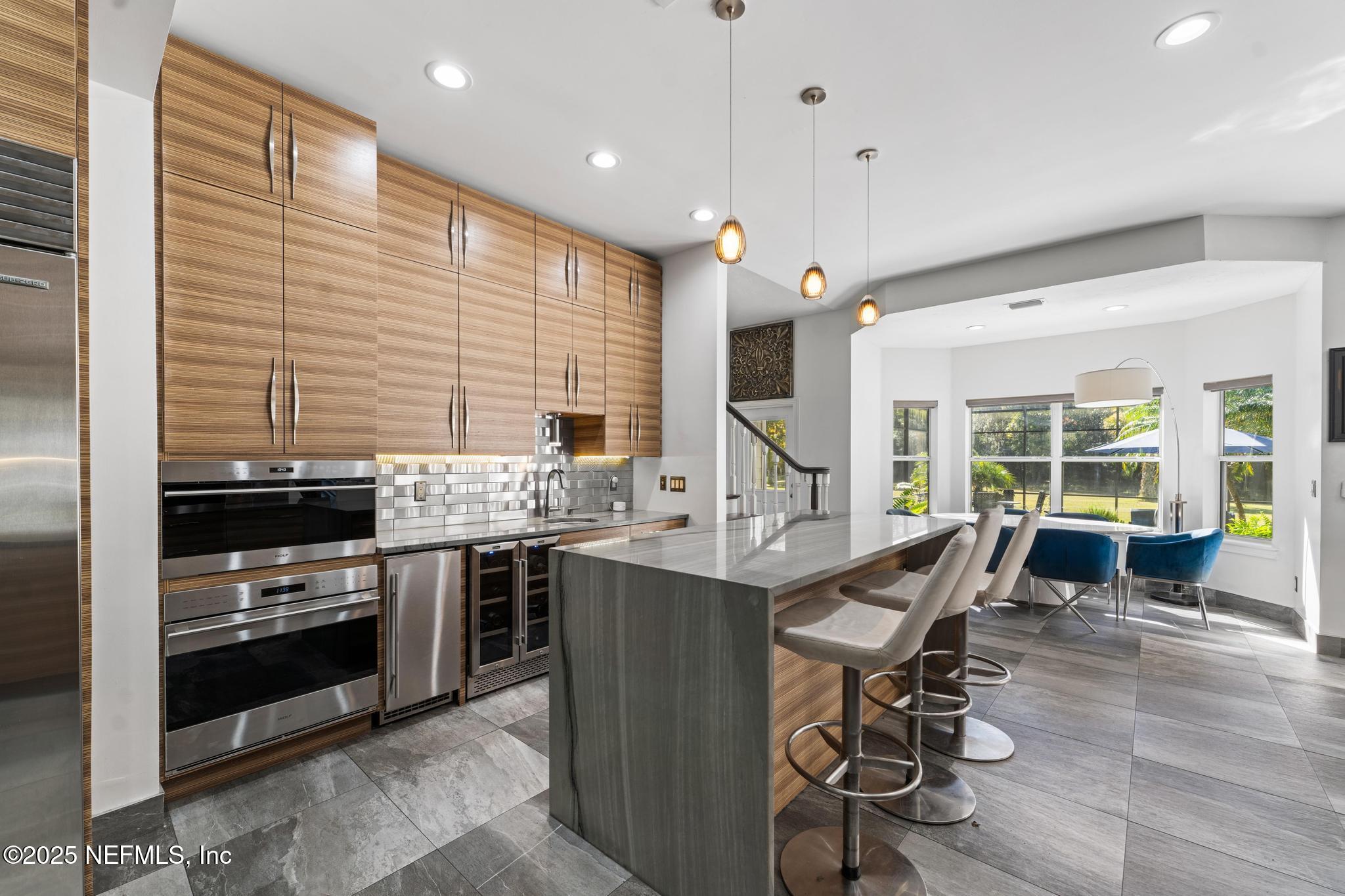 3010 Starratt Road Jacksonville, FL 32226 - Photo 31 of 106 a kitchen with stainless steel appliances granite countertop a stove and a view of living room
