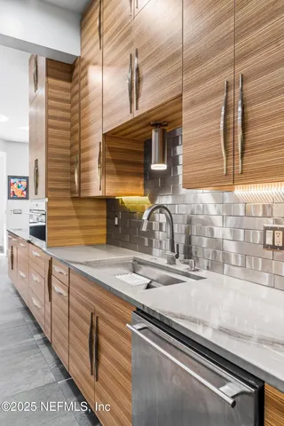 a bedroom with a balcony a bed and a large window with a chandelier