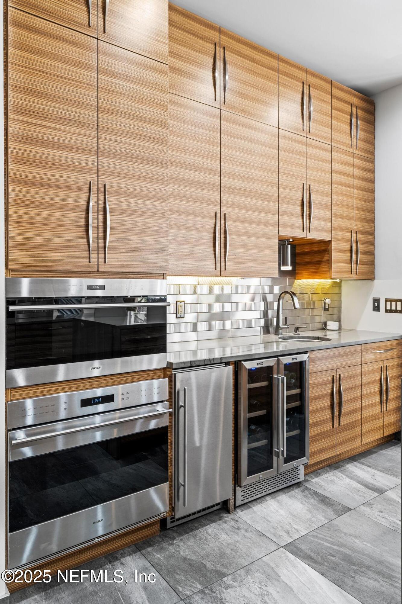 3010 Starratt Road Jacksonville, FL 32226 - Photo 37 of 106 a kitchen with stainless steel appliances kitchen island wooden cabinets and a stove top oven