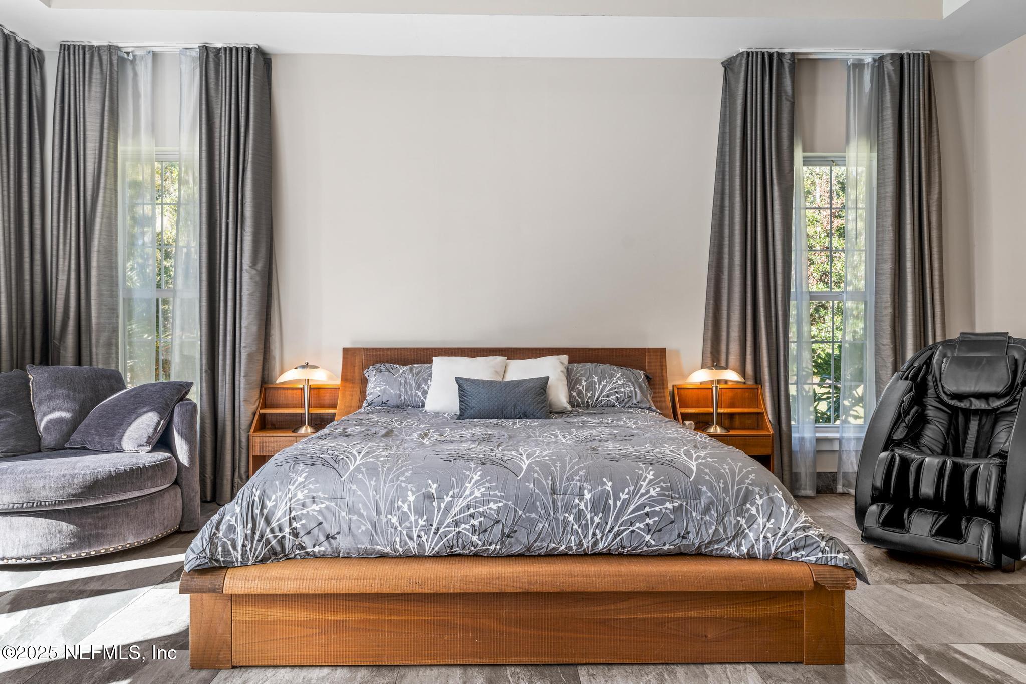 3010 Starratt Road Jacksonville, FL 32226 - Photo 43 of 106 a bedroom with a bed and a dresser next to a window