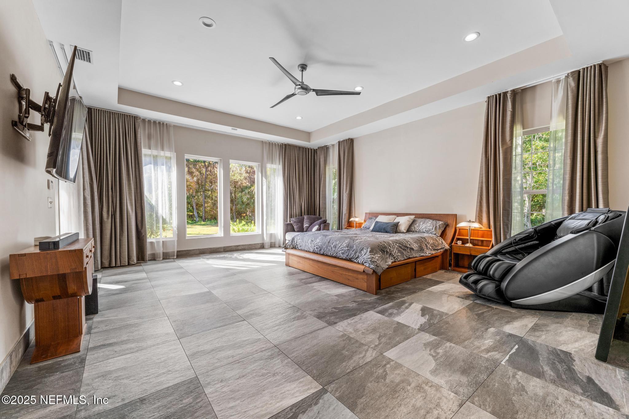 3010 Starratt Road Jacksonville, FL 32226 - Photo 44 of 106 a spacious bedroom with a bed and glass windows