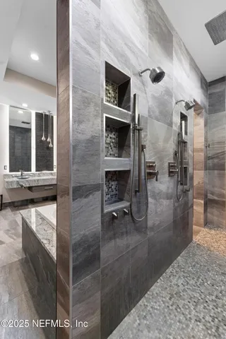 a view of a house with a small yard and a large tree