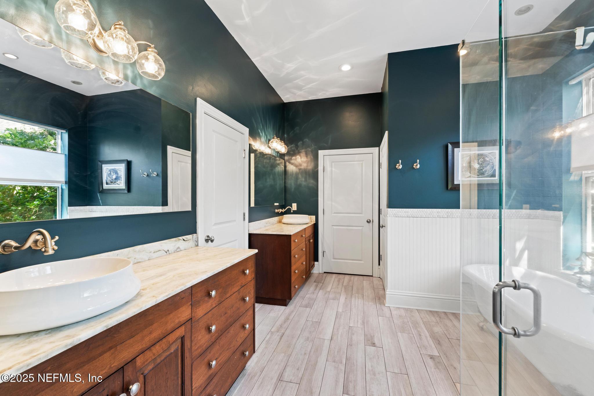 3010 Starratt Road Jacksonville, FL 32226 - Photo 58 of 106 a spacious bathroom with a double vanity sink a large mirror and shower