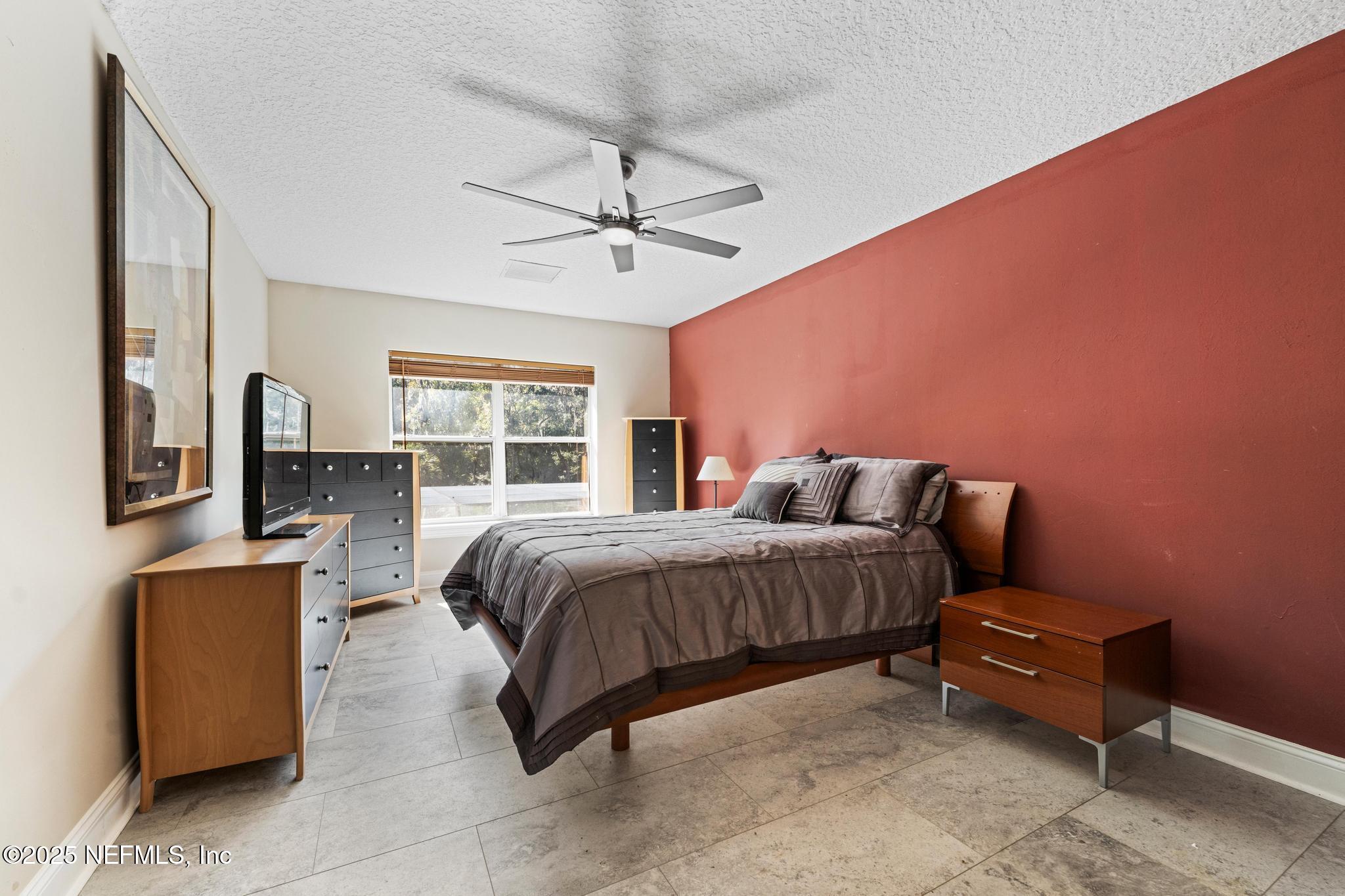 3010 Starratt Road Jacksonville, FL 32226 - Photo 64 of 106 a spacious bedroom with a bed and wooden floor