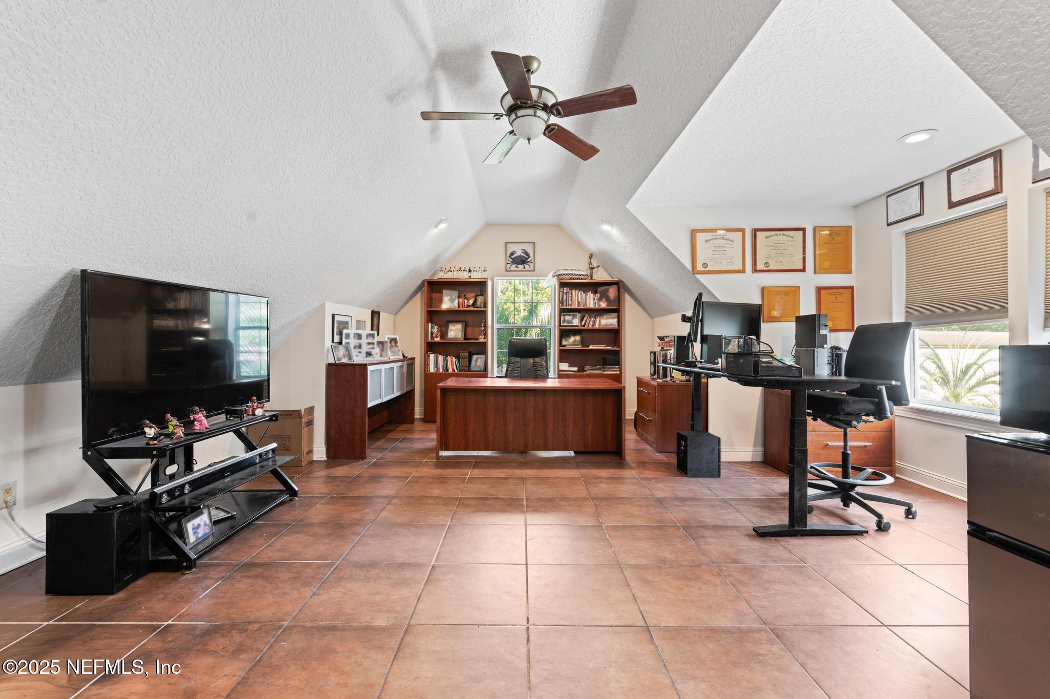 3010 Starratt Road Jacksonville, FL 32226 - Photo 72 of 106 a living room with furniture a flat screen tv and a window