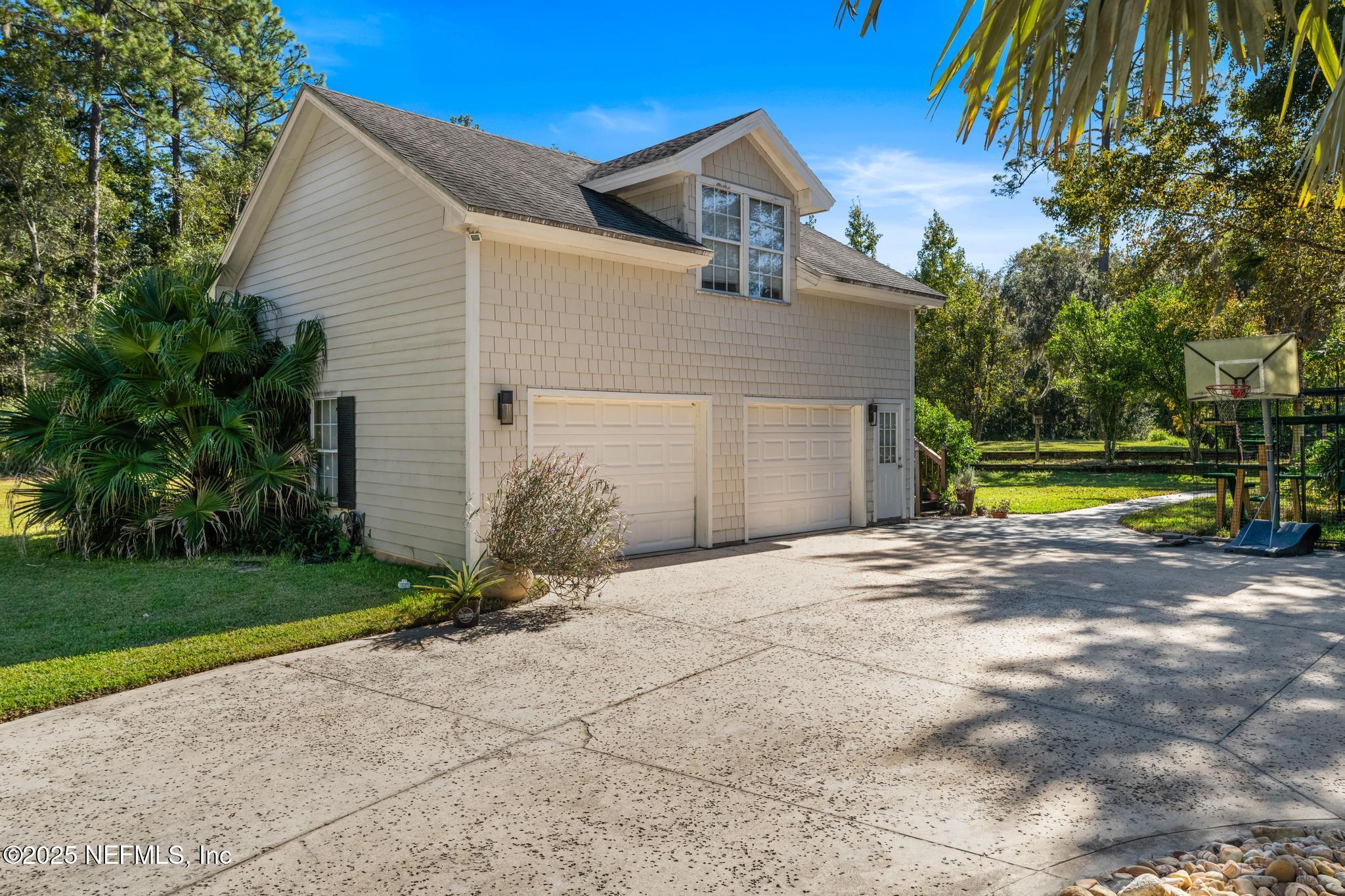 3010 Starratt Road Jacksonville, FL 32226 - Photo 97 of 106 a view of a house with a yard and large tree