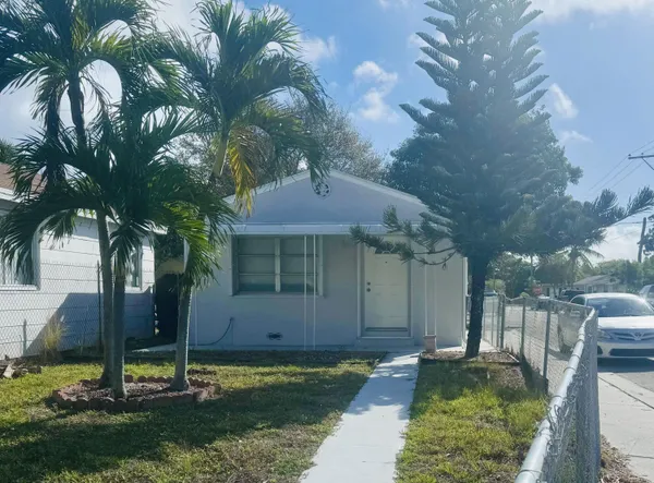 a backyard of a house with yard and trampoline