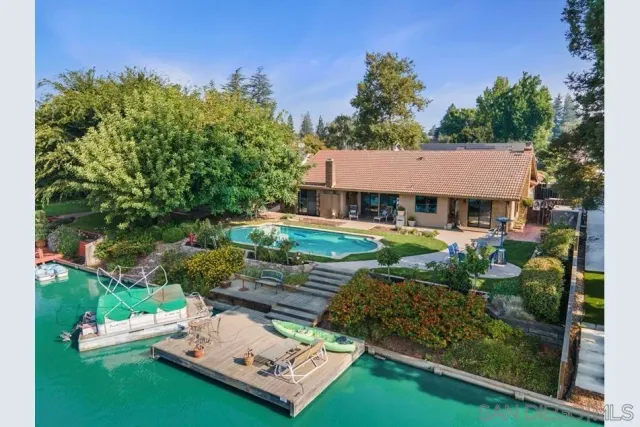 an aerial view of a house with swimming pool garden and patio