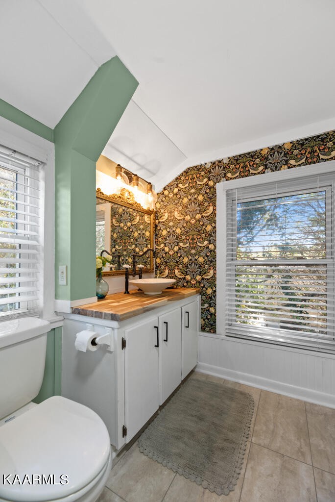 171 Garden Road Norris, TN 37828 - Photo 16 of 33 a bathroom with a granite countertop toilet a sink and a large window