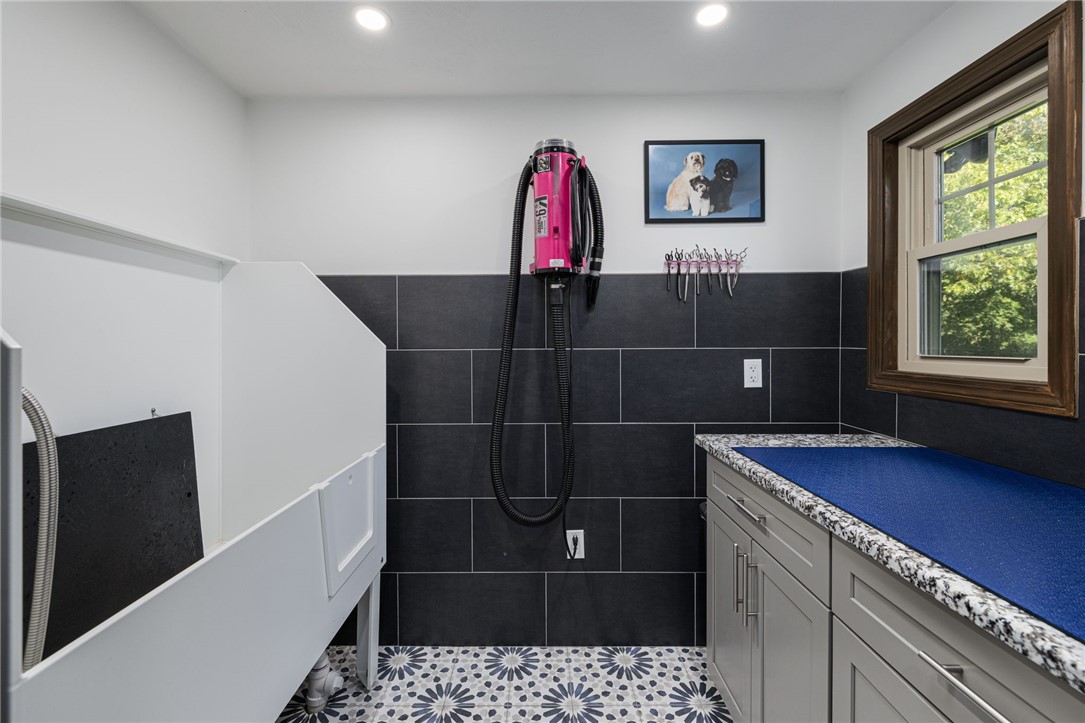 365 West Wrentham Road Cumberland, RI 02864 - Photo 11 of 50 This room can easily be reconfigured back to a full bath. Current owners are utilizing it as a dog grooming station. Located just off mud room.