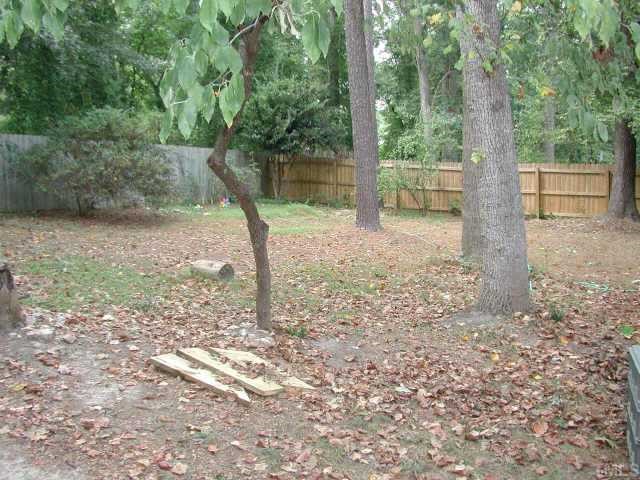 1413 Princess Anne Road Raleigh, NC 27607 - Photo 6 of 7 a backyard of a house with large trees and plants