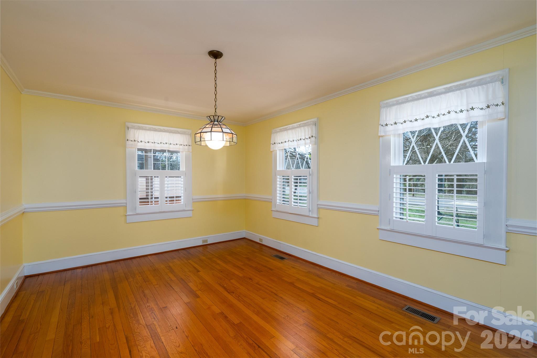 541 Union Street South Concord, NC 28025 - Photo 13 of 29 a view of an empty room with wooden floor and a window