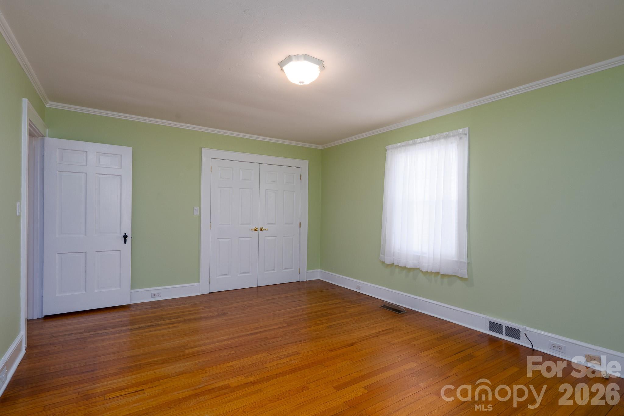541 Union Street South Concord, NC 28025 - Photo 14 of 29 a view of an empty room with wooden floor and a window