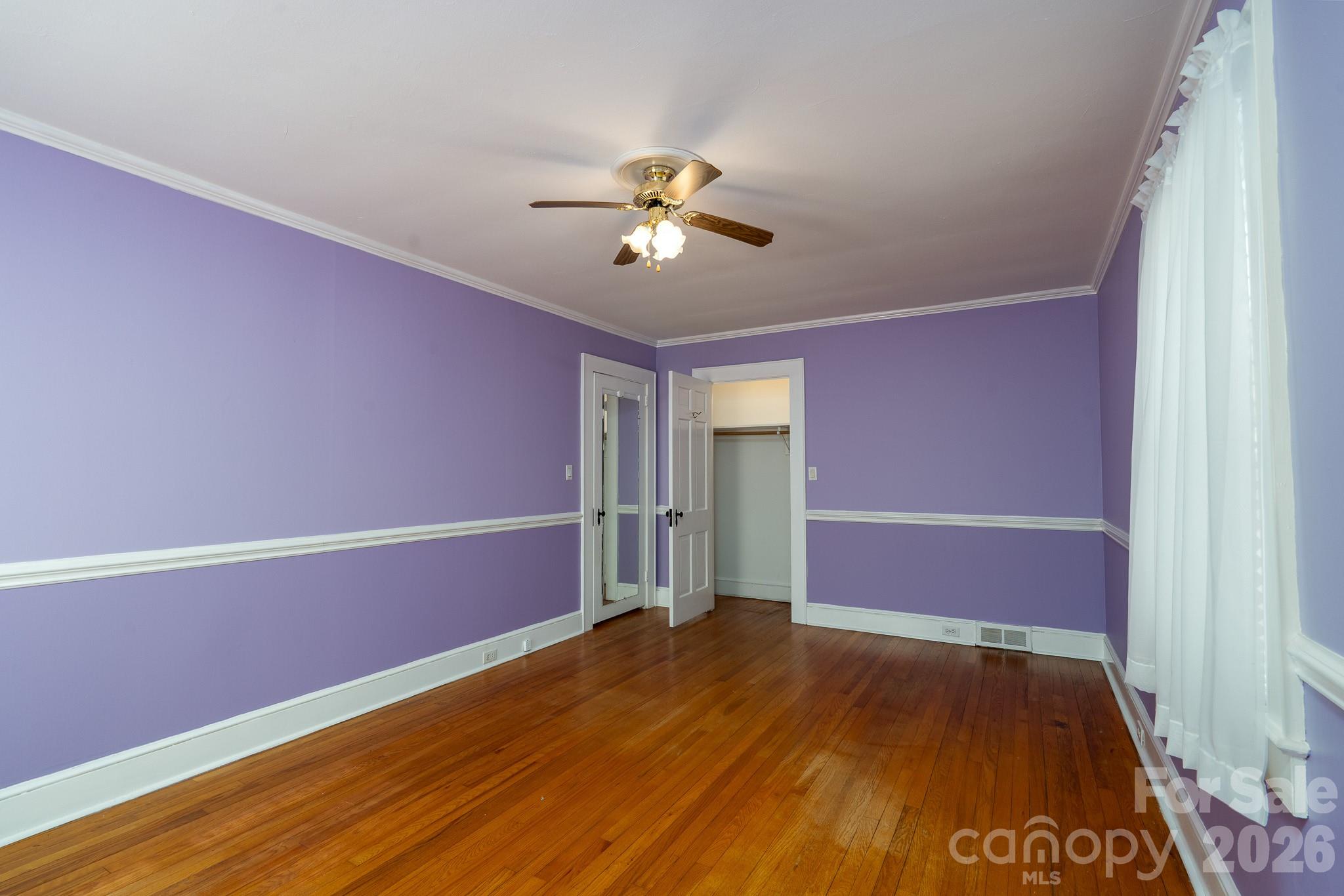 541 Union Street South Concord, NC 28025 - Photo 19 of 29 a view of room with hardwood floor and a ceiling fan