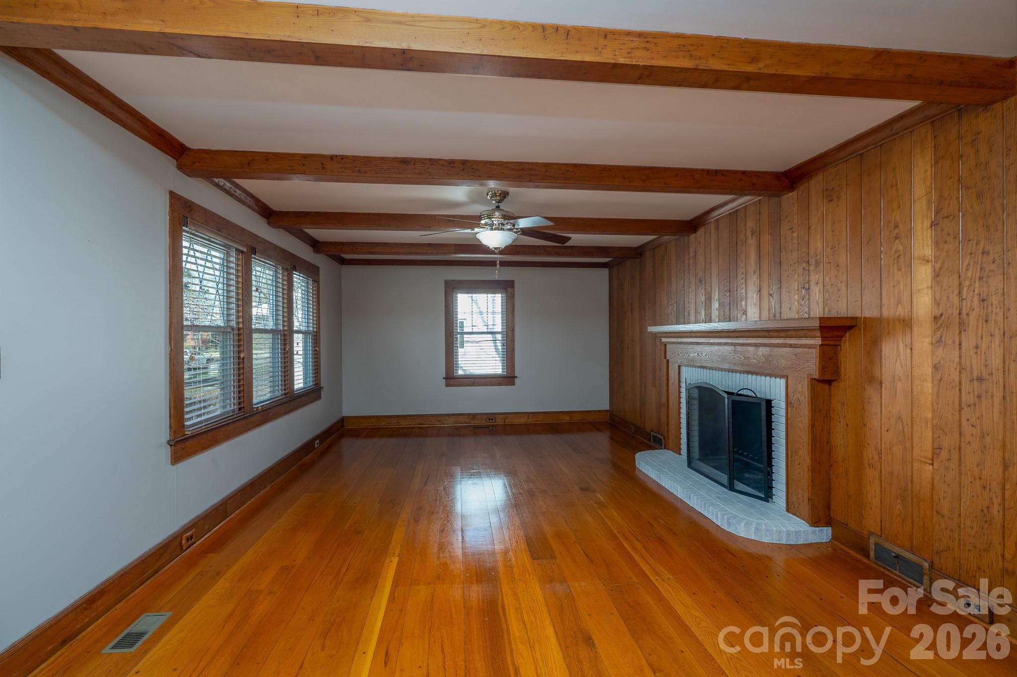 541 Union Street South Concord, NC 28025 - Photo 5 of 29 a view of an empty room with wooden floor fireplace and a window