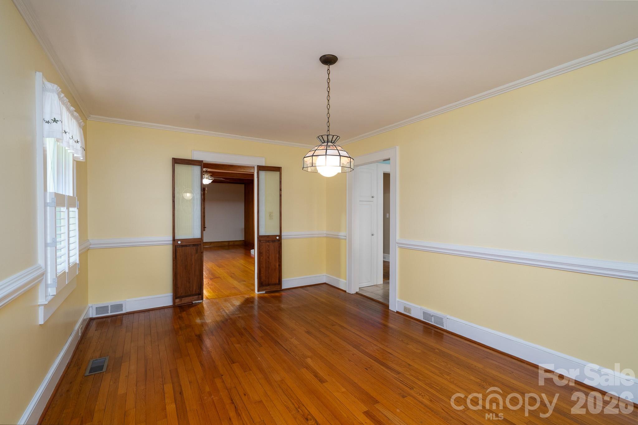 541 Union Street South Concord, NC 28025 - Photo 6 of 29 a view of empty room with wooden floor and fan