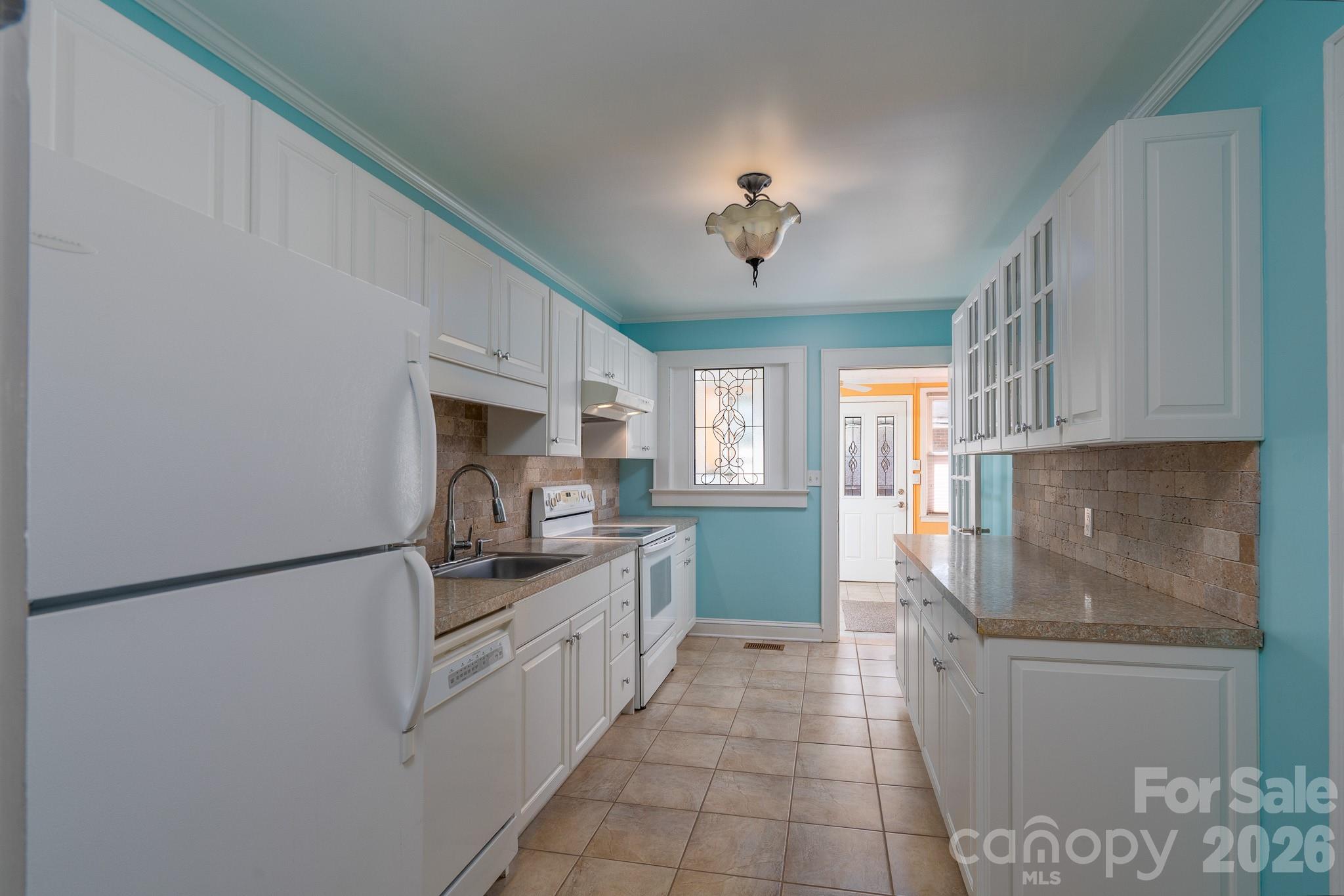 541 Union Street South Concord, NC 28025 - Photo 9 of 29 a kitchen with stainless steel appliances granite countertop a sink and cabinets