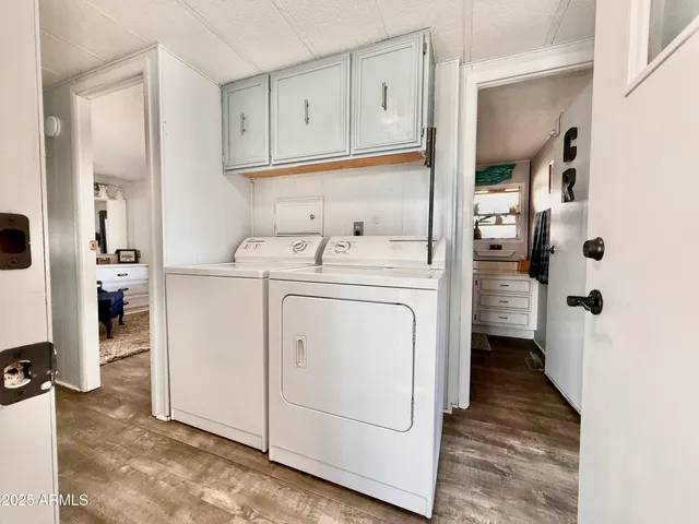 a utility room with cabinets washer and dryer