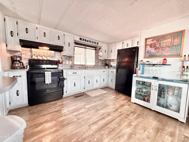 a kitchen with stainless steel appliances granite countertop a refrigerator and microwave