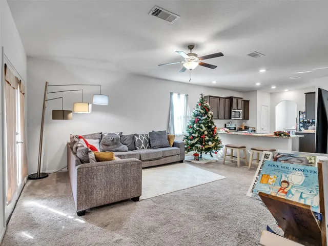 a living room with furniture and kitchen view