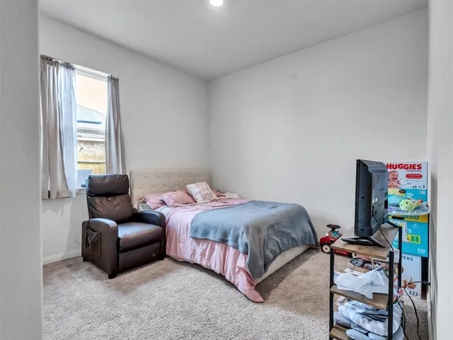 a bedroom with a bed and a couch