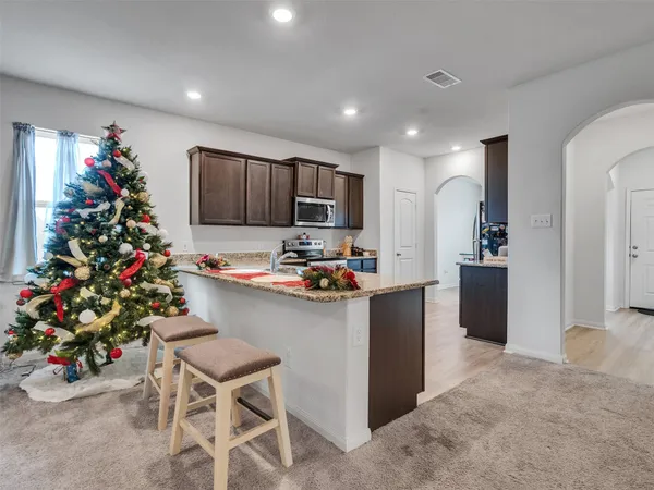 a kitchen with granite countertop a sink and cabinets