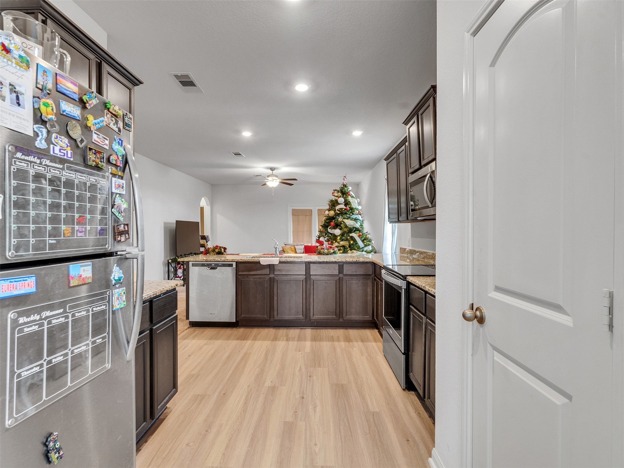 2123 Mule Ridge Drive Katy, TX 77493 - Photo 9 of 22 a kitchen with stainless steel appliances a large counter top a stove top oven a sink and a refrigerator