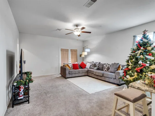 a living room with furniture and flowers