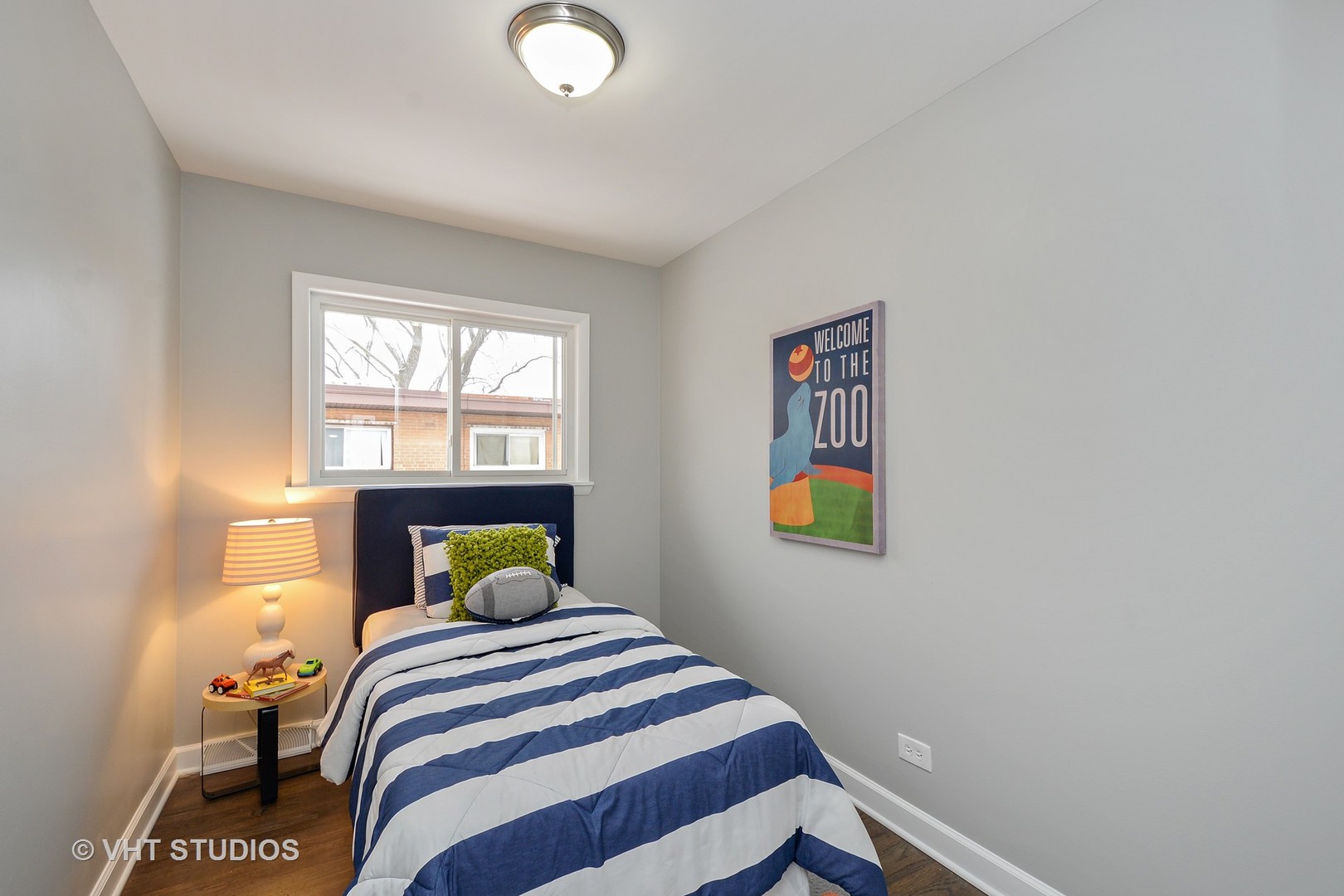 10077 Frontage Road, Unit E Skokie, IL 60077 - Photo 7 of 10 a bedroom with a bed and a window