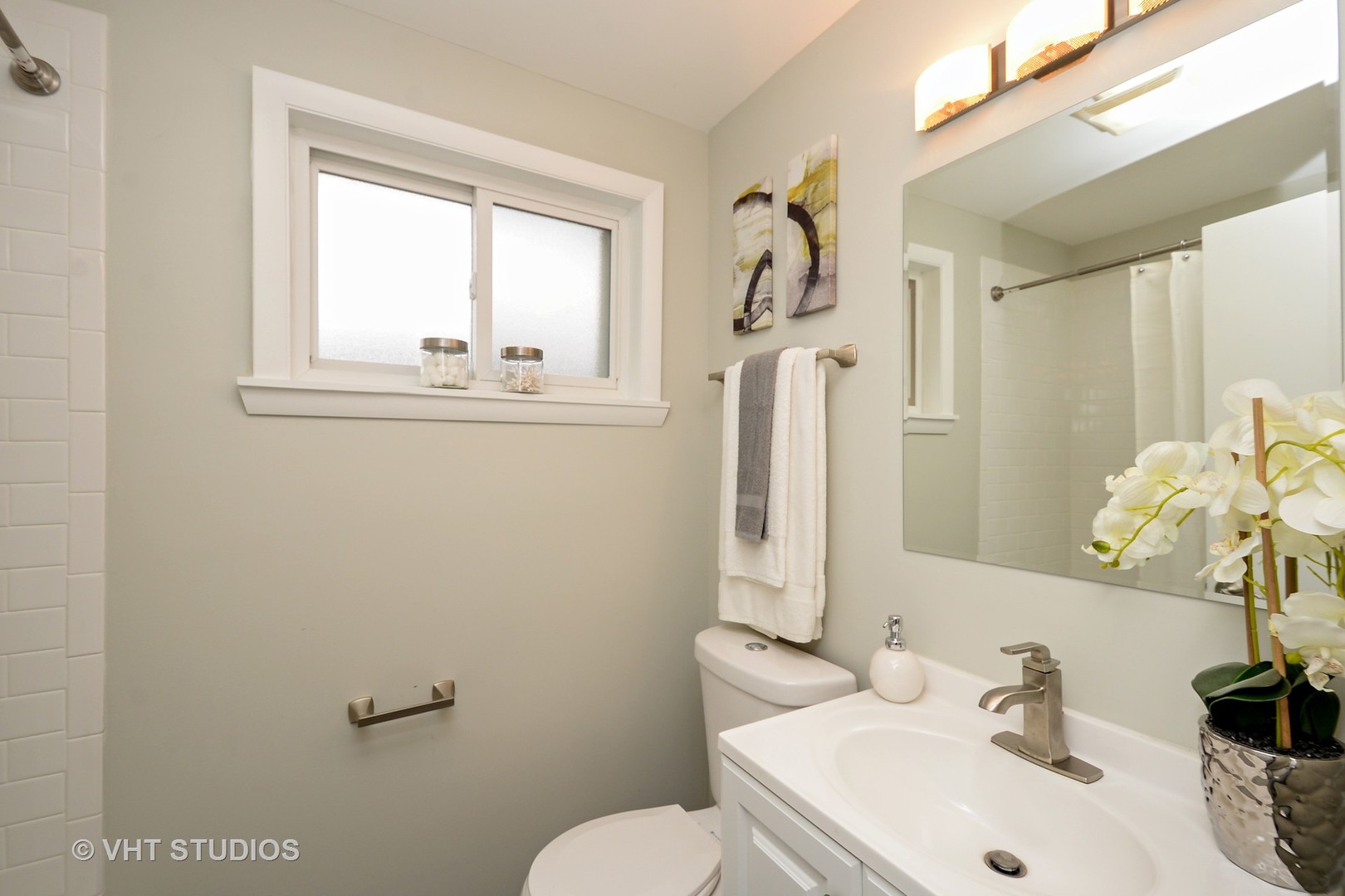 10077 Frontage Road, Unit E Skokie, IL 60077 - Photo 8 of 10 a bathroom with a sink mirror and toilet
