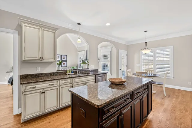 a kitchen with stainless steel appliances granite countertop stove top oven and cabinets