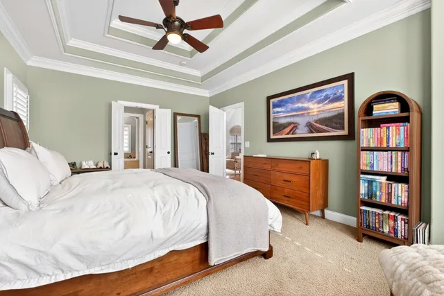 a spacious bedroom with a bed and a book shelf