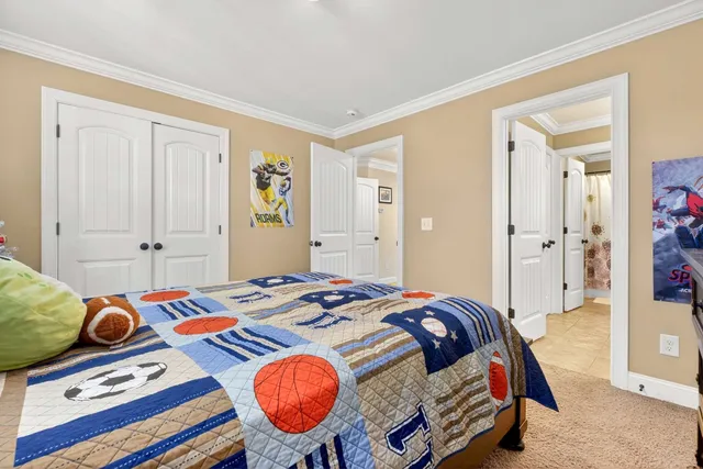 a bedroom with bed and wooden floor