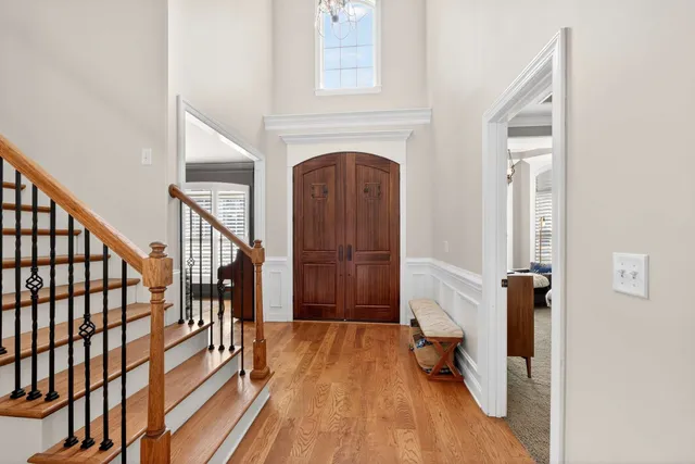 a view of front door with wooden floor and stairs