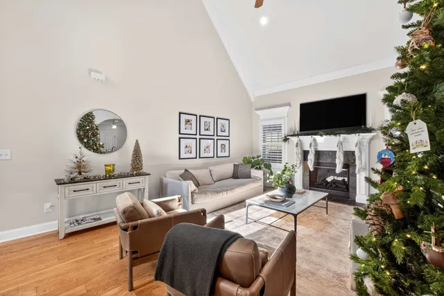 a living room with furniture a flat screen tv and a fireplace