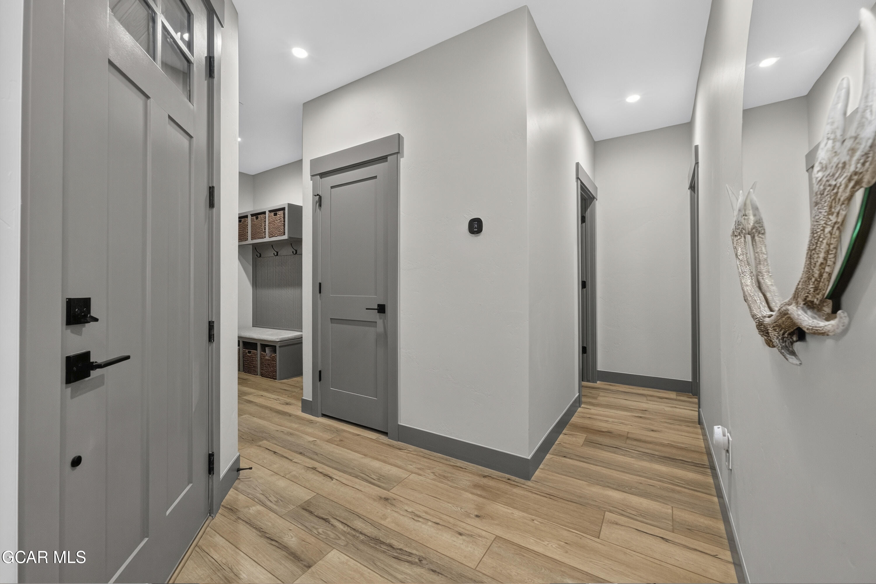 154 Eagle Ridge Drive Granby, CO 80446 - Photo 5 of 59 a view of a hallway with wooden floor and a bathroom