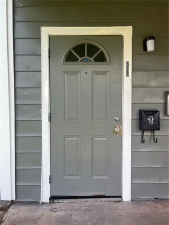a view of front door and bedroom