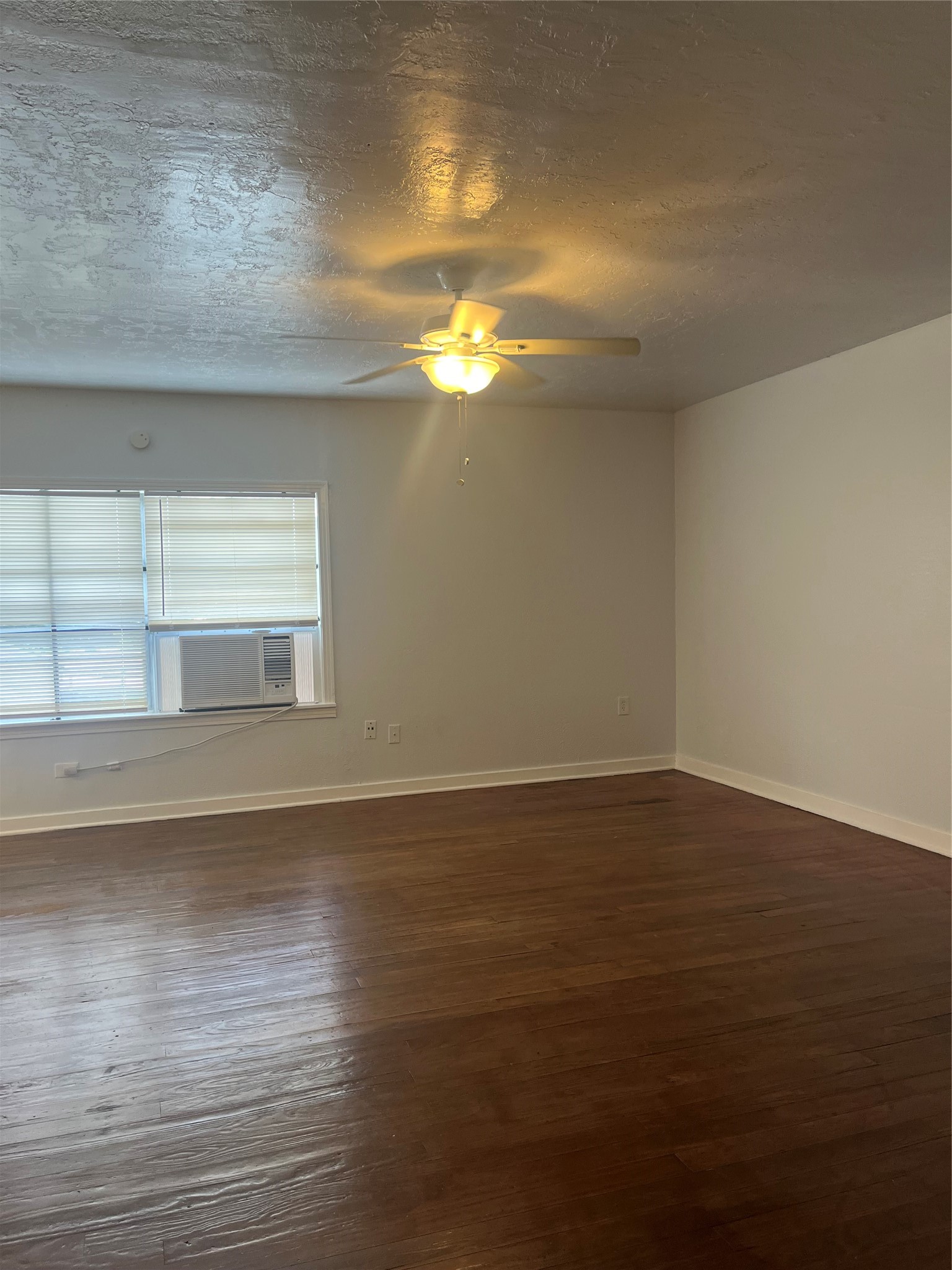 5537 Bataan Road, Unit B Houston, TX 77033 - Photo 6 of 13 a view of empty room with wooden floor and fan