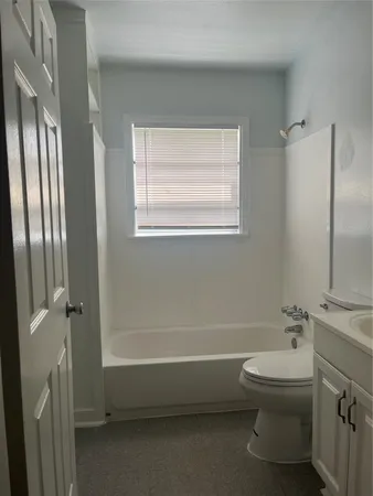 a bathroom with a toilet a sink and a bathtub